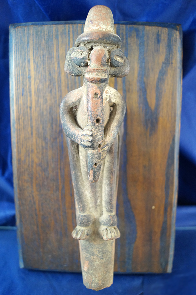 Very ornate mounted Tripod vessel leg fragment that is 8" tall depicting a musician - Costa Rica.