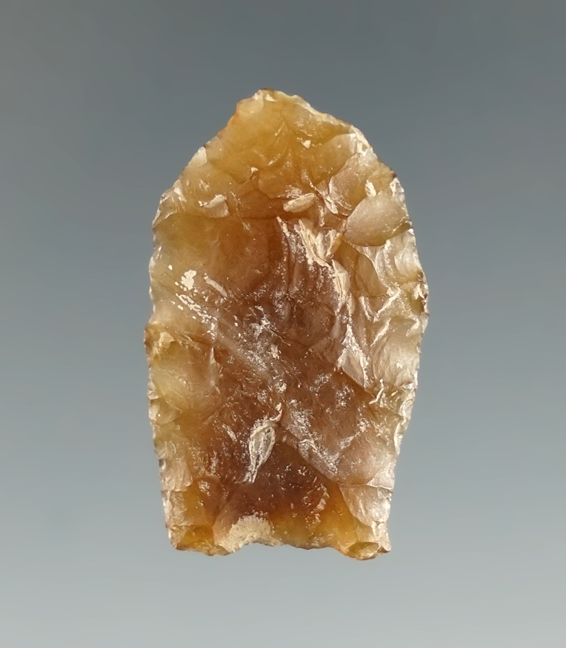 1 1/8" Paleo dart point made from Knife River Flint with nicely ground lower edges and base. Found i