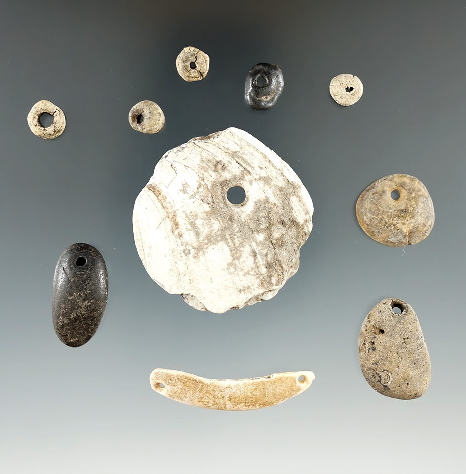 Group of 10 assorted drilled ornaments found in Eastern South Dakota. Largest is 1 5/8".