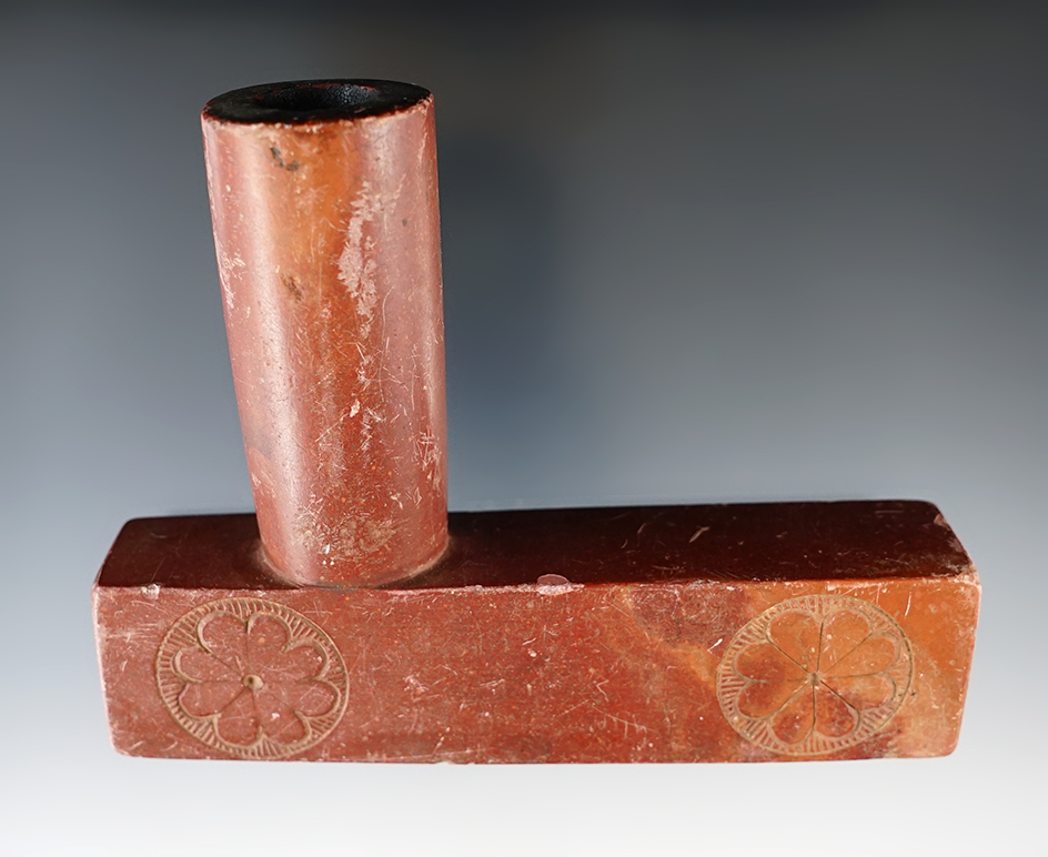 Old 4 11/16" Catlinite pipe that is heavily patinated. Nicely carved floral rosettes. Circa 1880's.
