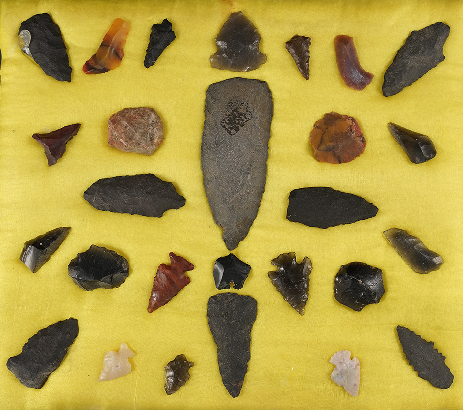 Group of surface found flaked artifacts from New Mexico glued to a board. Largest is 2 7/8".