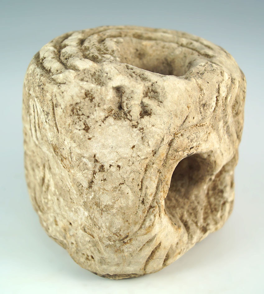 Highly engraved 2 3/4" stone with two drilled holes which was found on a basement shelf…..