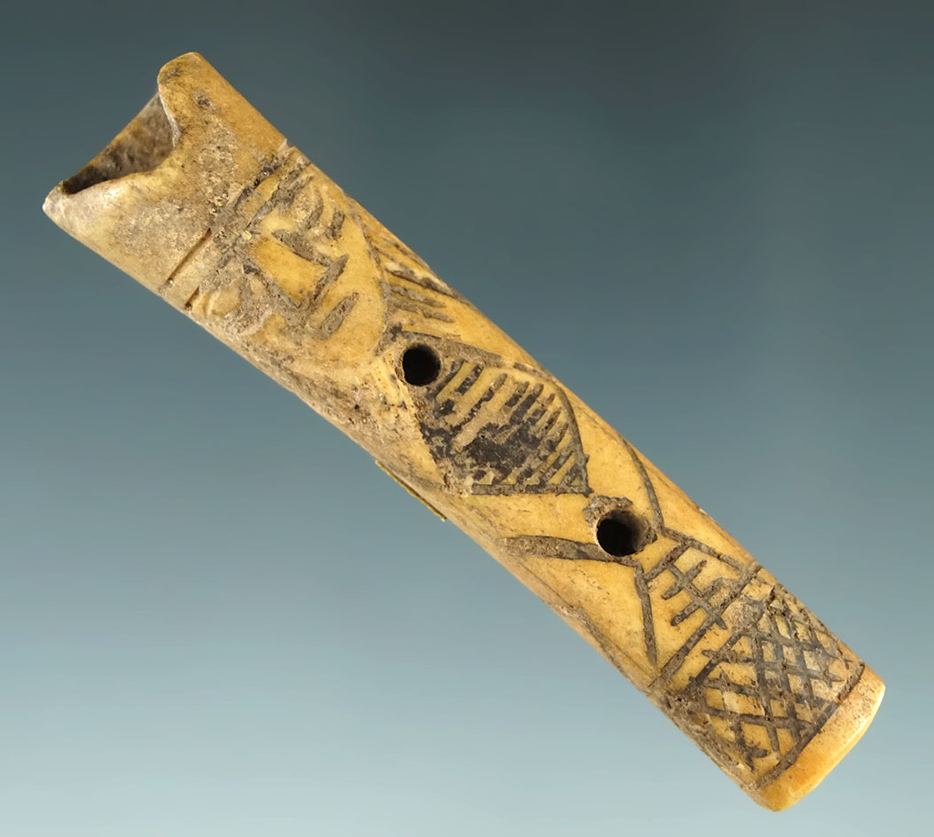 Altiplano type engraved llama bone flute with the face and form of a human. Nicely incised. Peru.