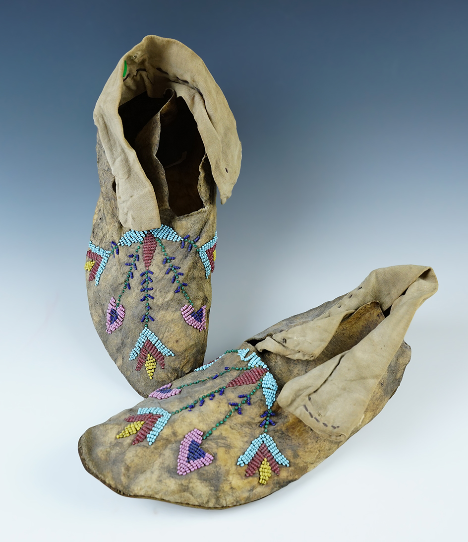 Pair of very old Moccasins with a beaded floral pattern design. 9" in length.