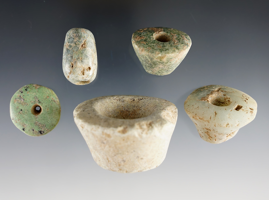 Group of 5 polished stone artifacts including 4 ear flares and one highly polished drilled bead.