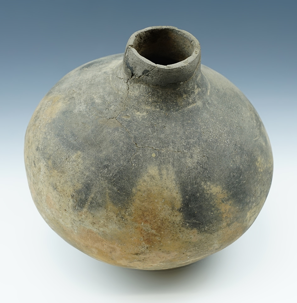 7 1/2" tall by 6 3/4" wide Short Neck Bottle w/ slight restoration to rim. Arkansas.