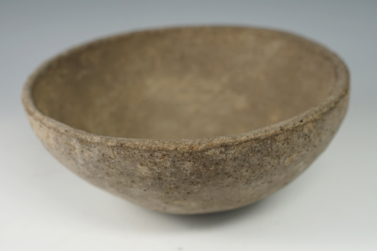 6 1/2" wide x 2 1/4" tall shell tempered clay pottery bowl. Some surface pressure cracks.