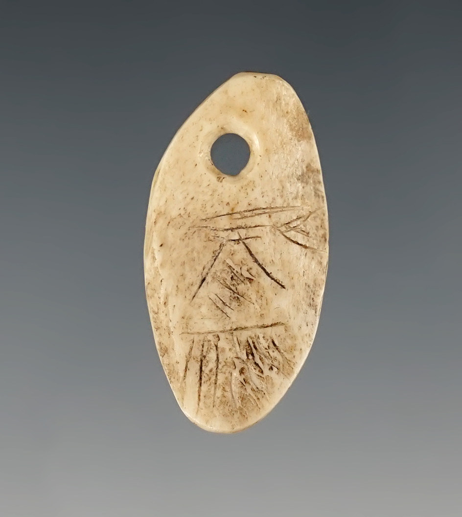 1 5/16"Drilled Bone Ornament with engravings. Found in Umatilla, Oregon.