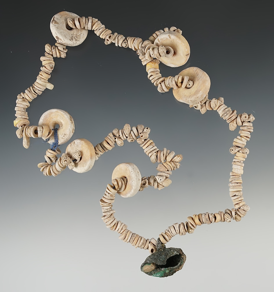 19" Strand of drilled Shell Beads with a copper ornament pendant. Found in New Mexico.