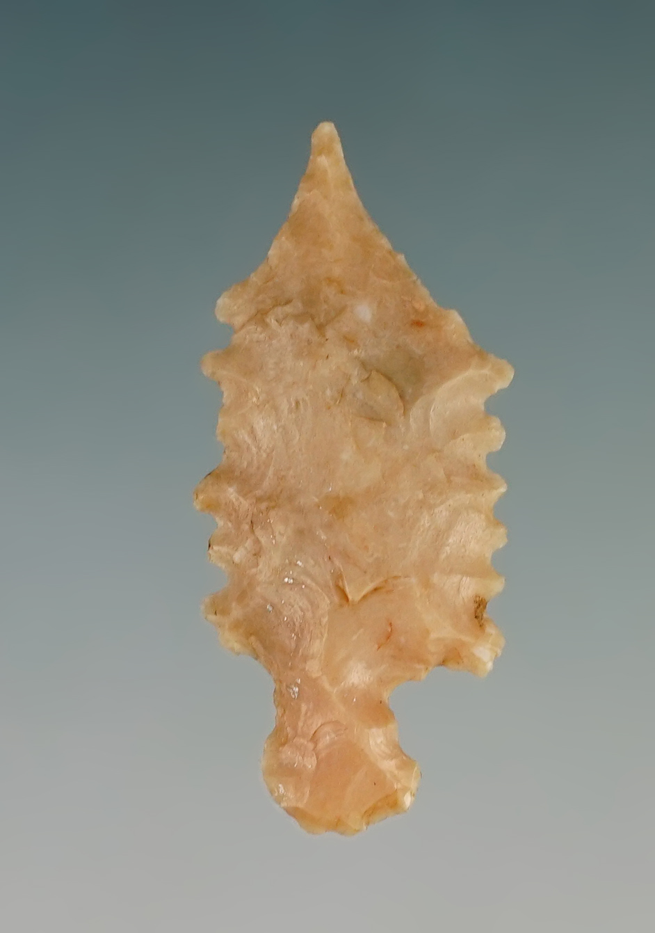 Outstanding serrations on this 1 1/8" Stemmed point found in New Mexico.