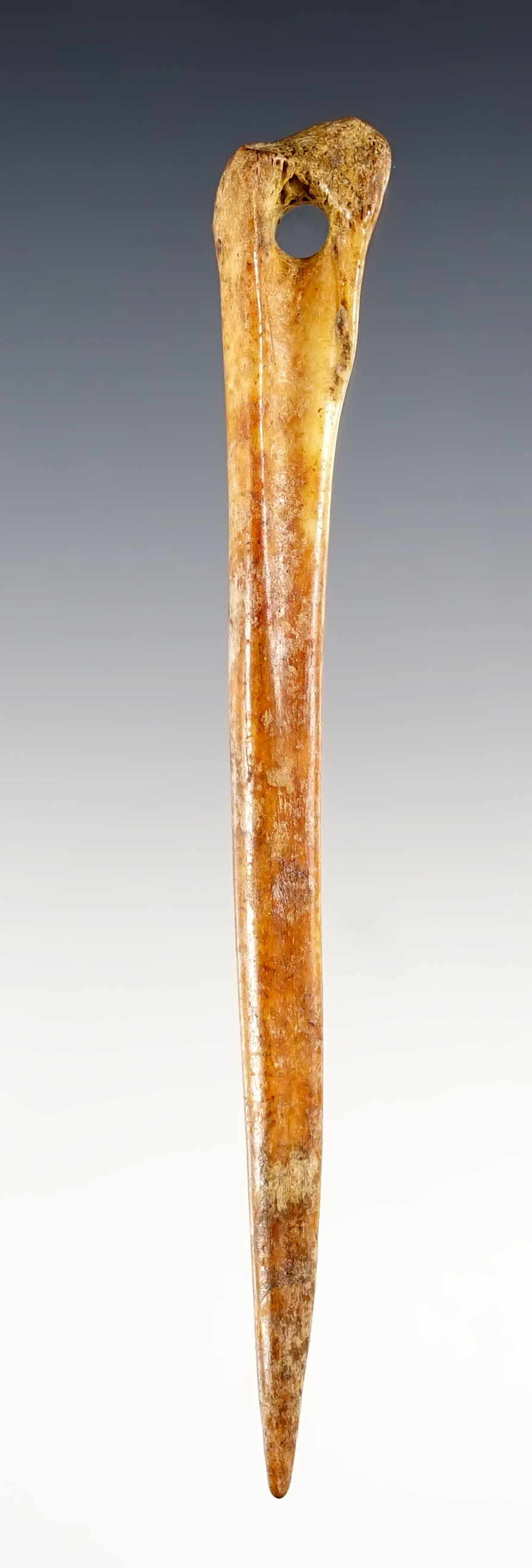 4 3/4" well crafted Bone Awl that is perforated. Found in Ohio.