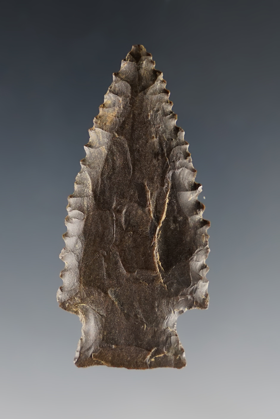 2 1/8" nicely serrated point made from Dover Flint found near the Tennessee River, Tennessee.