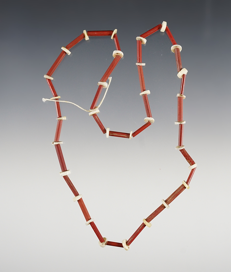 17" Strand of red straw and shell discs. Recovered at the Power House Site in Lima, New York. 