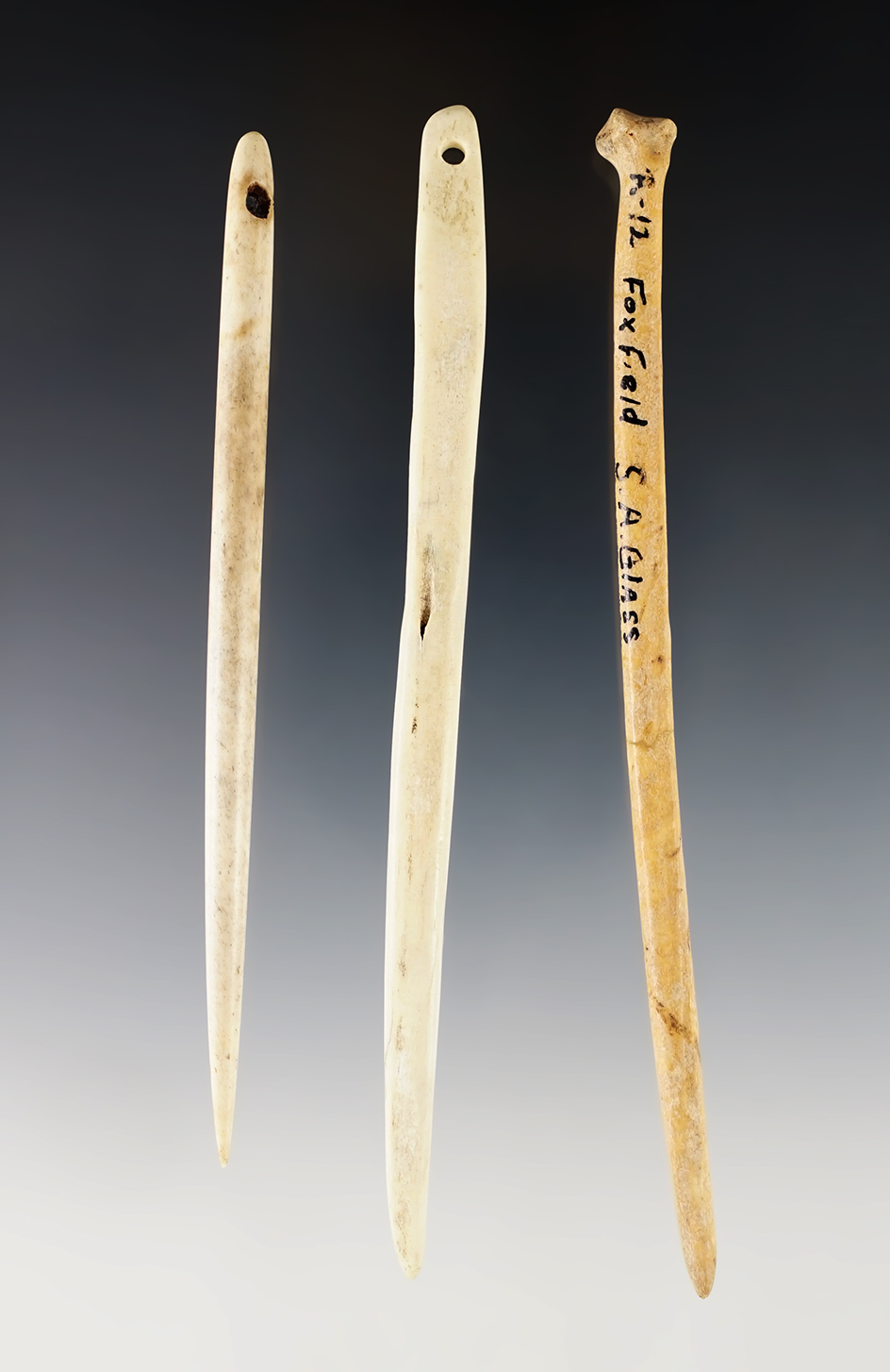 2 Bone Needles and a 5 1/4" Bone Awl that is broken/glued. Fox Field Site, Mason Co., Kentucky.