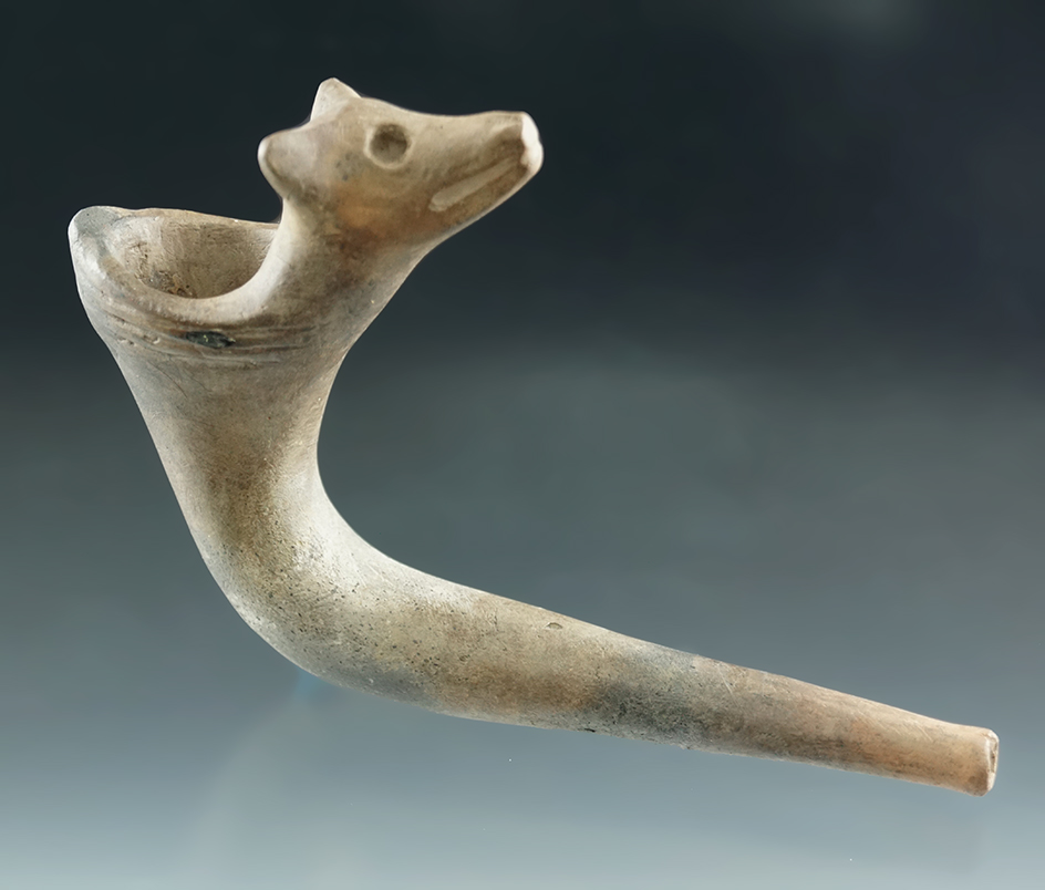 5 3/4" Wolf effigy clay pipe with partial restoration to the bowl, tip of one ear.  New York.