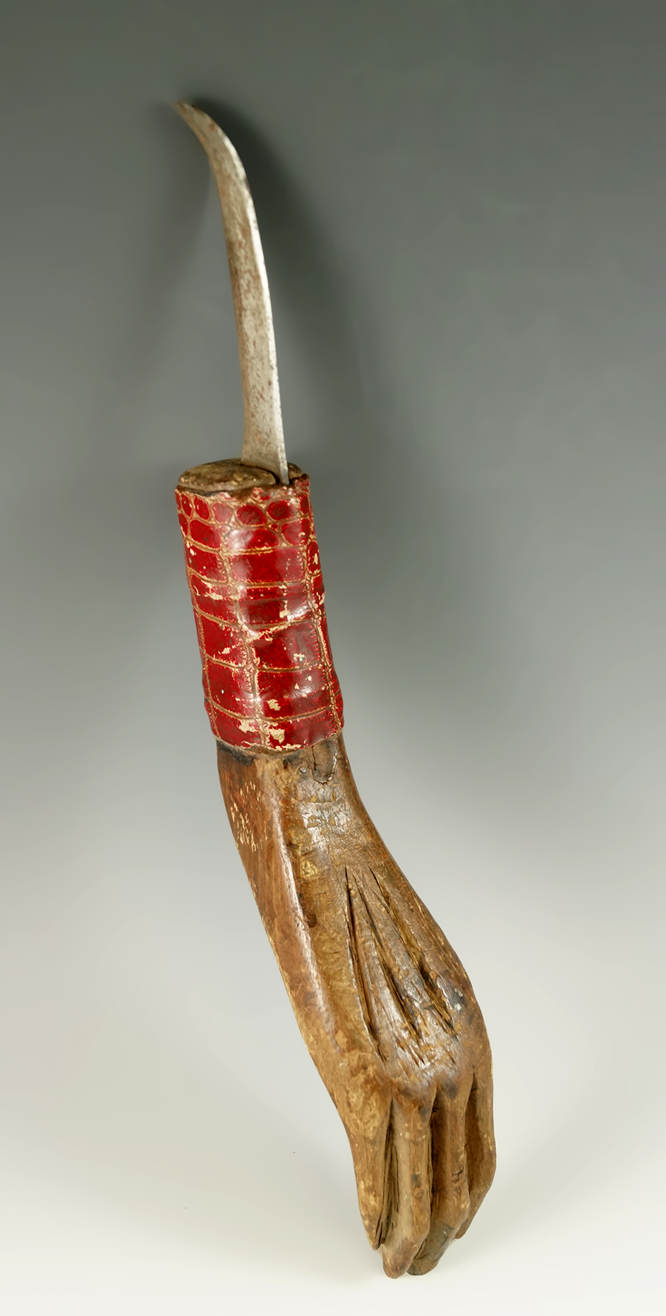 Very uniquely crafted 11 5/8" handcarved knife with a metal blade. Handle is shaped like a hand.