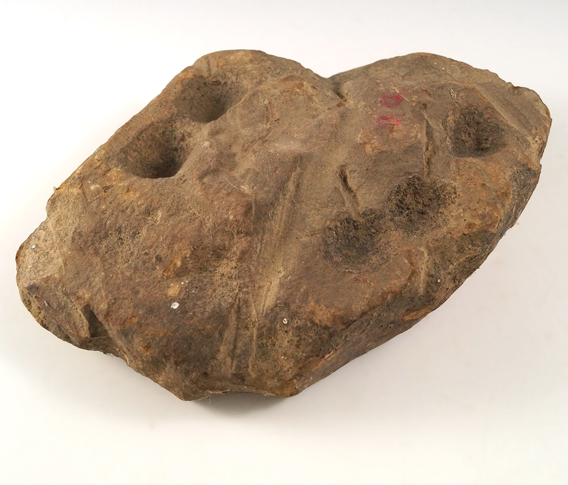 8 7/8" Nutting Stone with 11 divots (some on both sides).