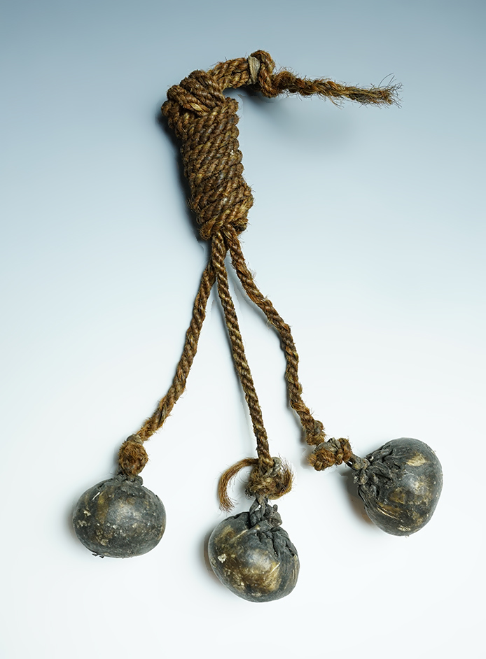 Bola, possibly Pre-Columbian (Inca) Peru/Bolivia, circa CE 1500. Fiber, Animal Hide and Stone.