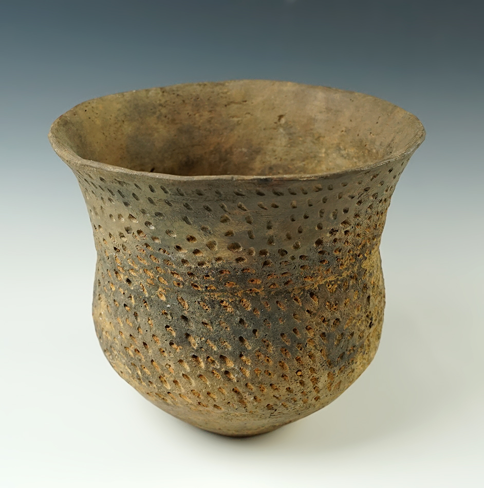 5 3/4" tall x 6 1/4" wide reed punctate pottery vessel with heavy restoration to rim area. 