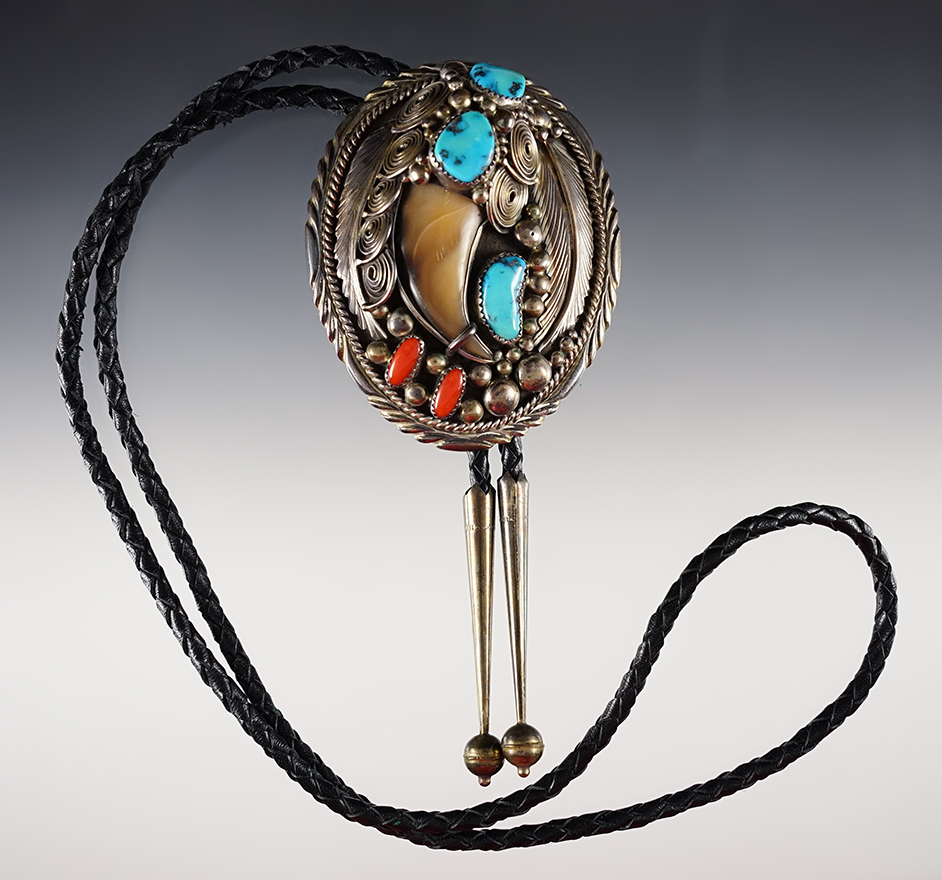 Bolo-tie with a 3" clasp that is stamped "Navajo handmade" with the initials "J.S."