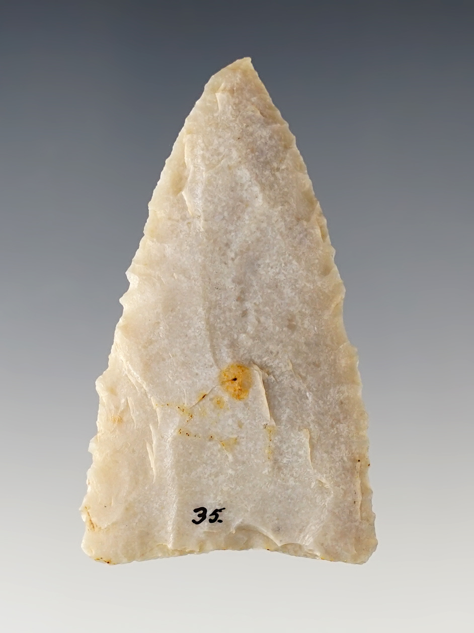 2 1/4" Early Triangle reportedly found in SE Wyoming. Made from cream-colored Agate. Rogers COA.