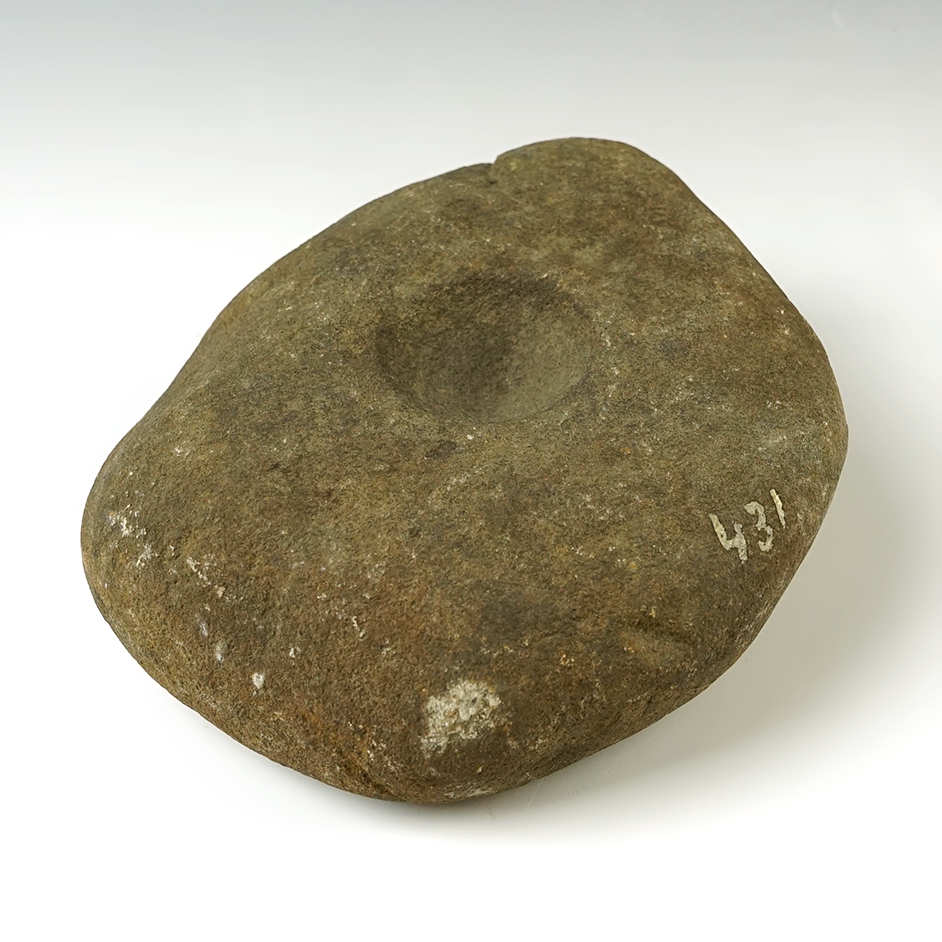 5 1/4" heavily patinated nutting stone with a divot on each side. Found in Ohio.