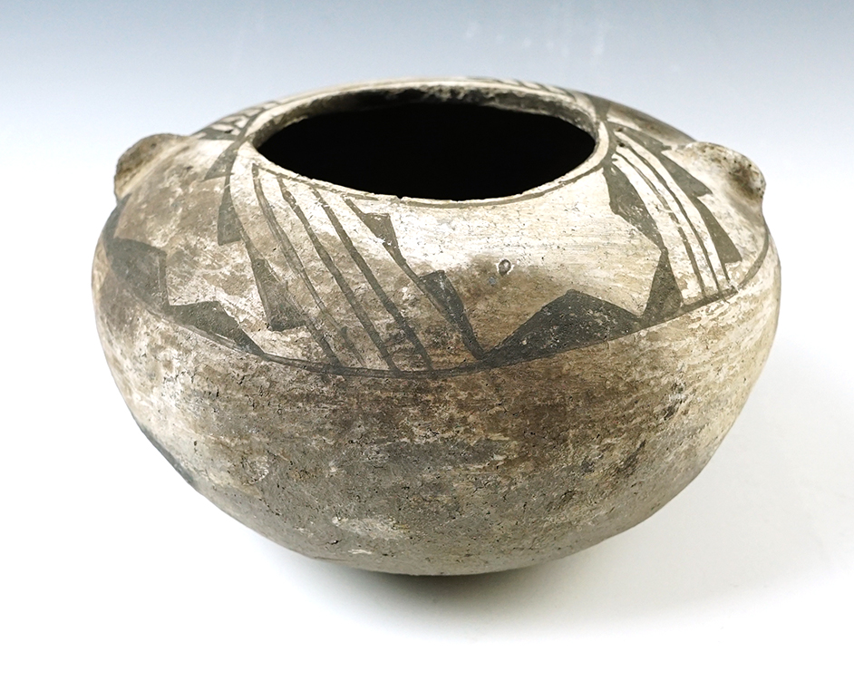 6 3/8" x 3 3/8" black and white Anasazi pottery jar with suspension holes on top.