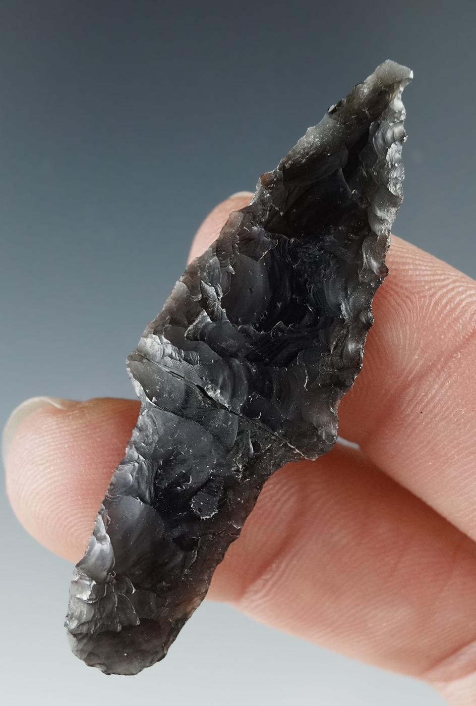 Excellent flaking and style on this 2" translucent obsidian Parman which is glued back tight.