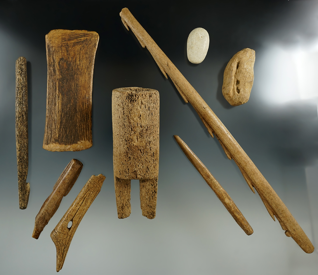Group of assorted bone artifacts in various conditions found in Alaska. Largest is 12" long