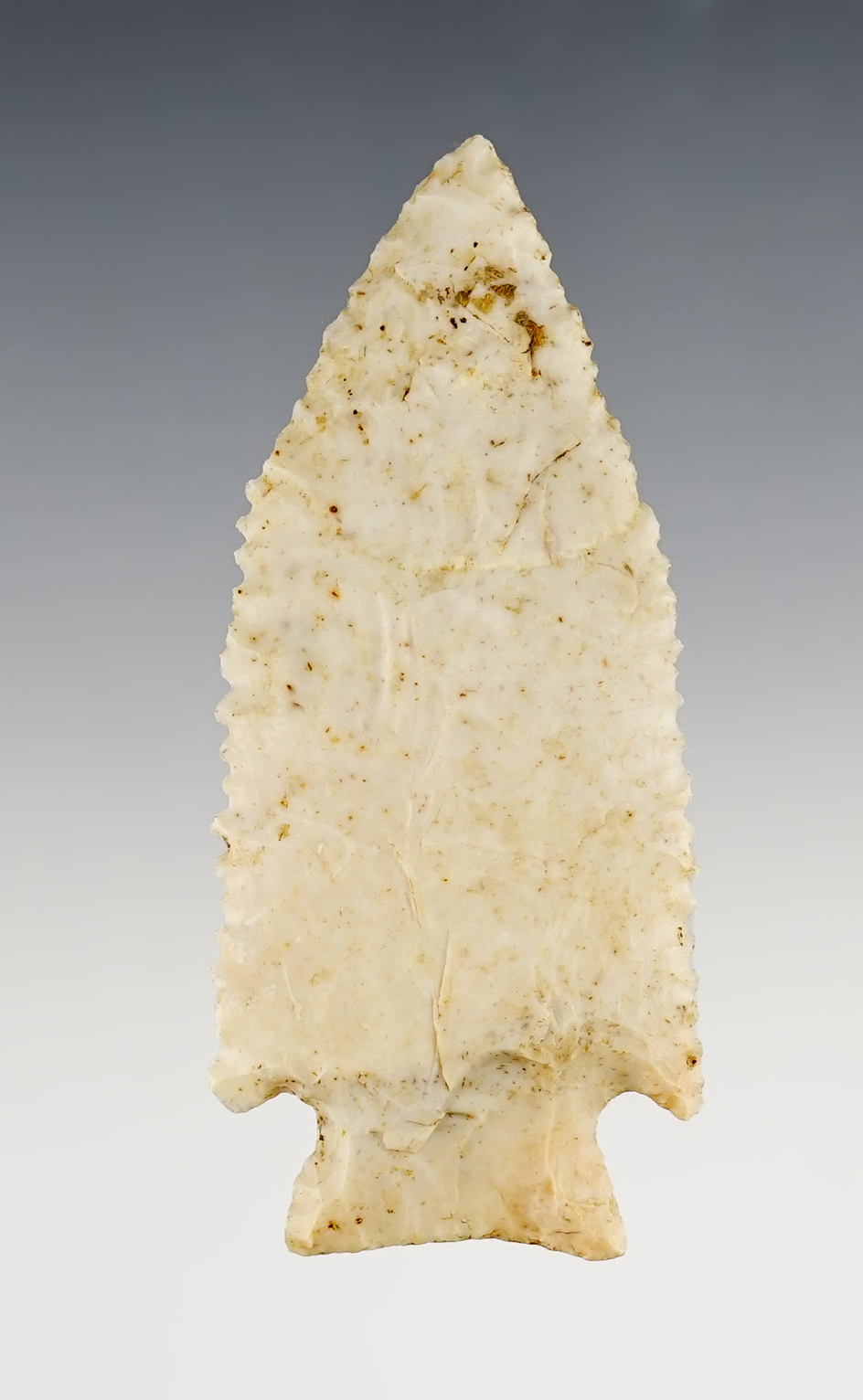 Finely serrated 3 7/16" Stilwell found in the Midwestern U.S. and made from high grade flint.