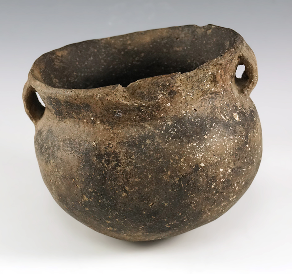 6" wide by 4 1/2" tall strap handled Mississippian pottery vessel found in Arkansas.