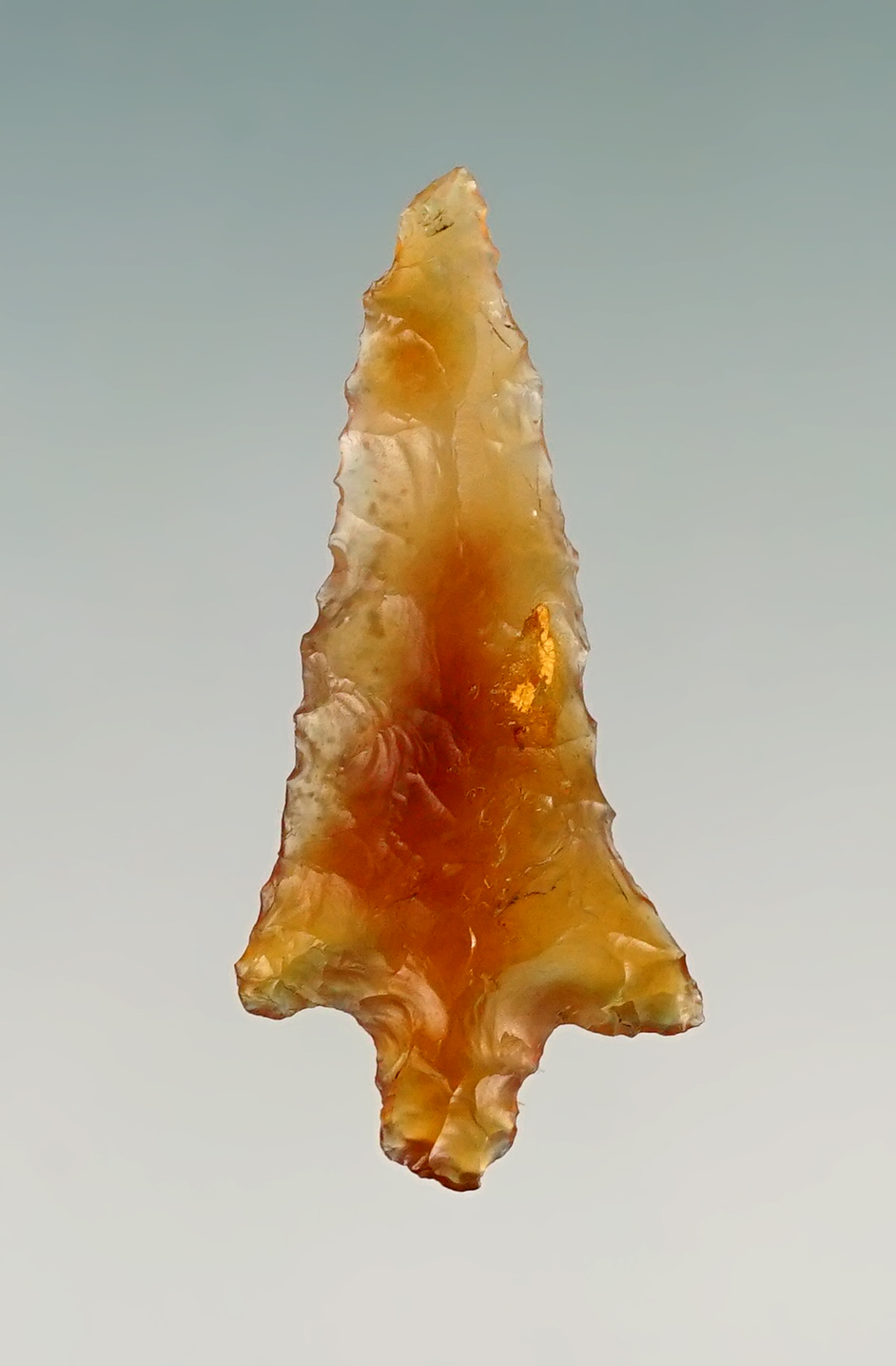 1" Stemmed Dart point made from translucent material. Found in the Four Corners area.
